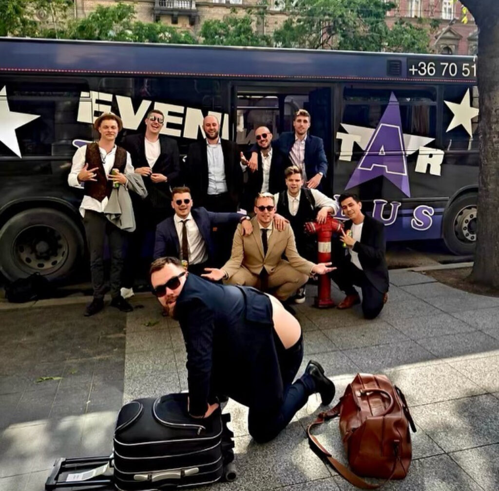 Party bus Budapest with a stag group front of it.